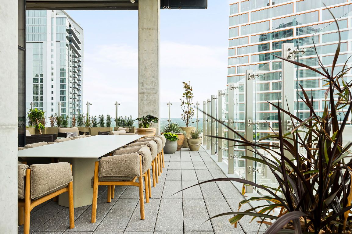 610 Davis Street, Unit 2812 Austin, TX 78701 - Photo 22 of 32 a view of a balcony with chairs and table in a patio