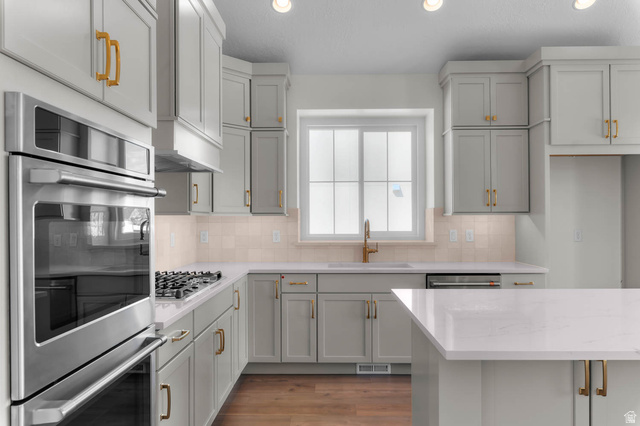 11749 South Halls Crk Road Draper, UT 84020 - Photo 15 of 21 Kitchen with stainless steel appliances, light wood-style flooring, recessed lighting, decorative backsplash, and light stone countertops