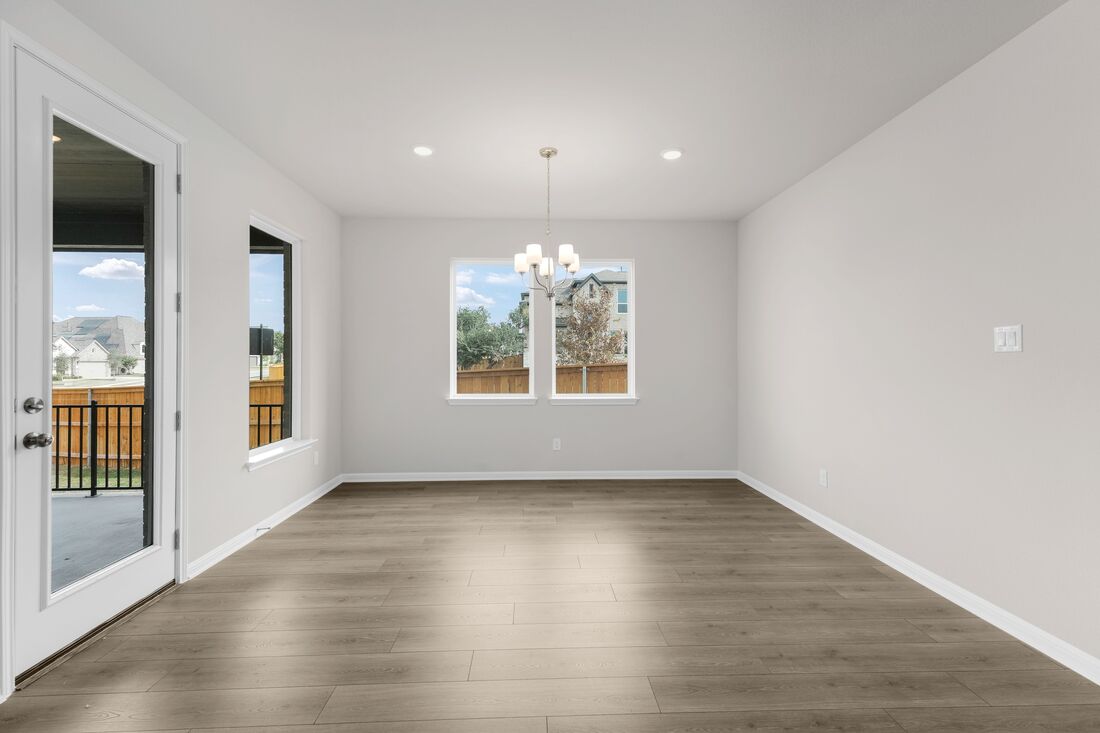 1821 Plum Tree Way Georgetown, TX 78628 - Photo 11 of 35 an empty room with wooden floor and windows