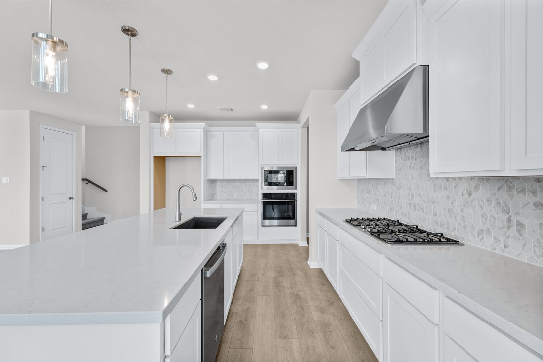 1821 Plum Tree Way Georgetown, TX 78628 - Photo 13 of 35 a kitchen with stainless steel appliances granite countertop a sink stove and refrigerator
