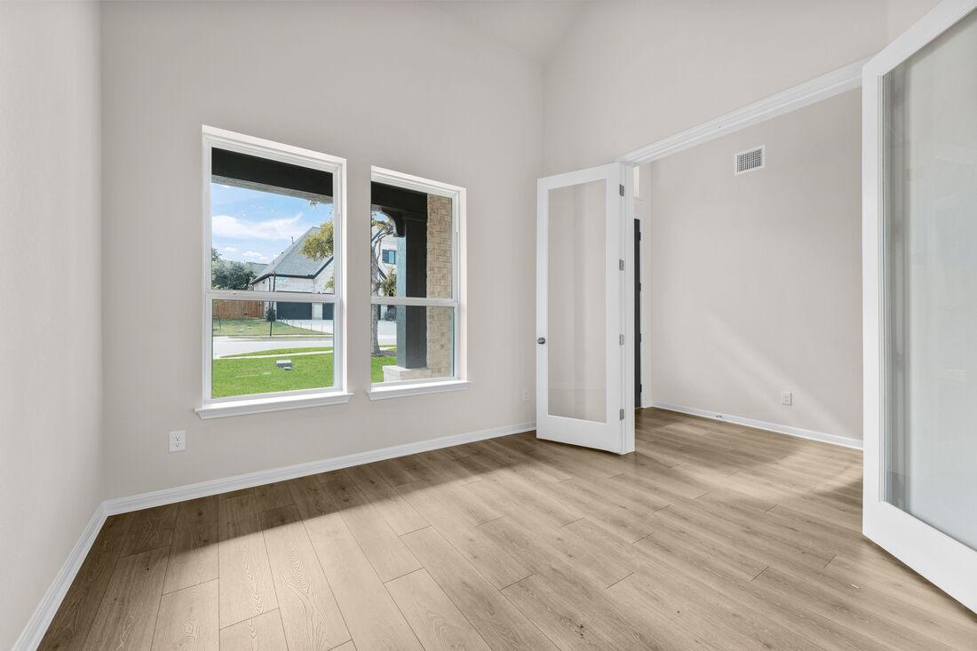 1821 Plum Tree Way Georgetown, TX 78628 - Photo 16 of 35 a view of an empty room with wooden floor and a window