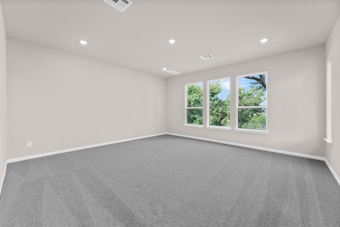 1821 Plum Tree Way Georgetown, TX 78628 - Photo 17 of 35 an empty room with wooden floor and windows