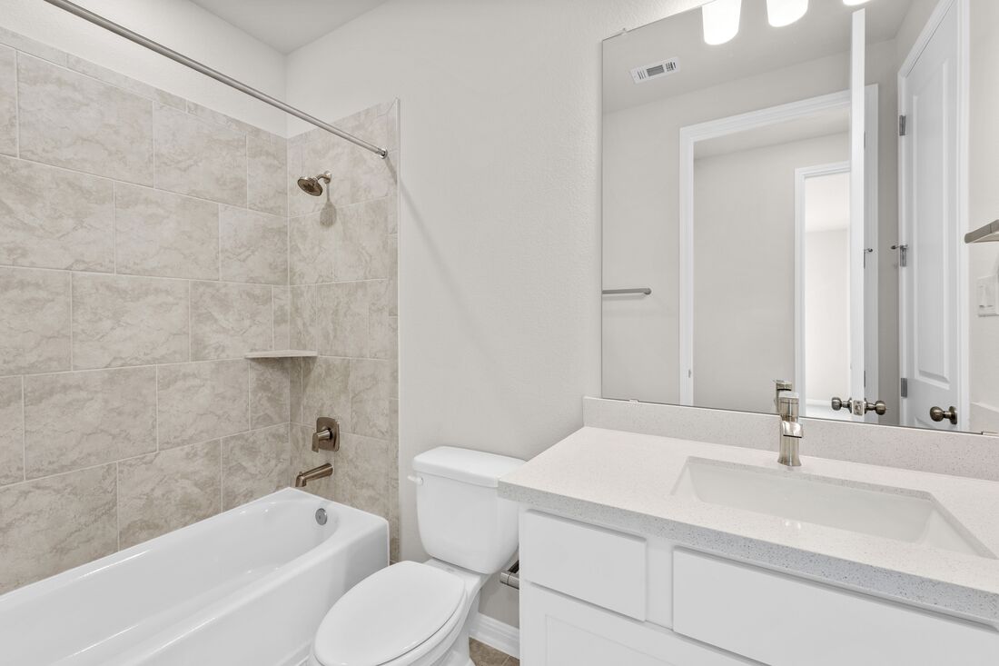 1821 Plum Tree Way Georgetown, TX 78628 - Photo 4 of 35 a bathroom with a sink toilet vanity and shower