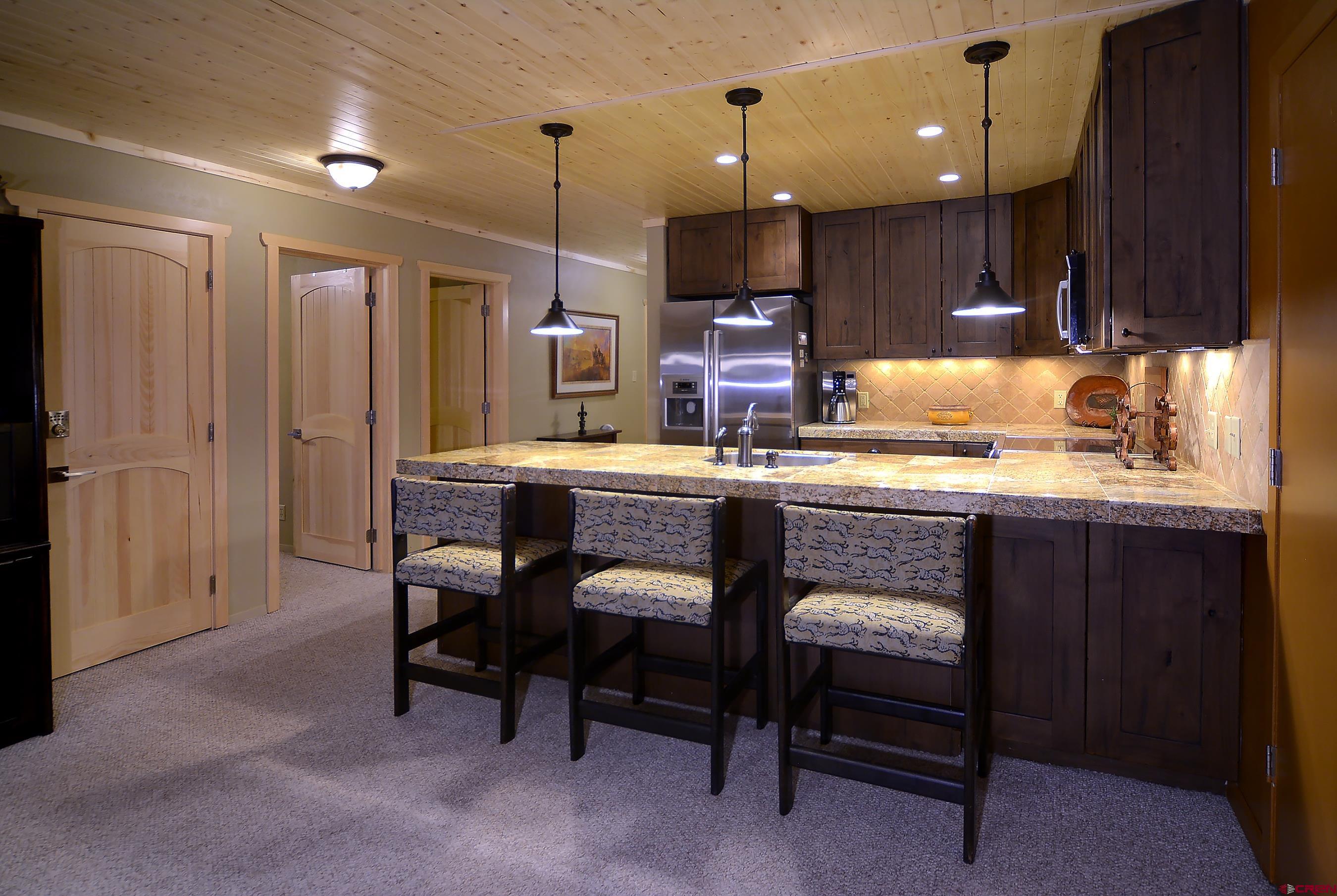 35 Emmons Road, Unit 3 Crested Butte, CO 81225 - Photo 11 of 25 a kitchen with a sink a cabinets and chairs