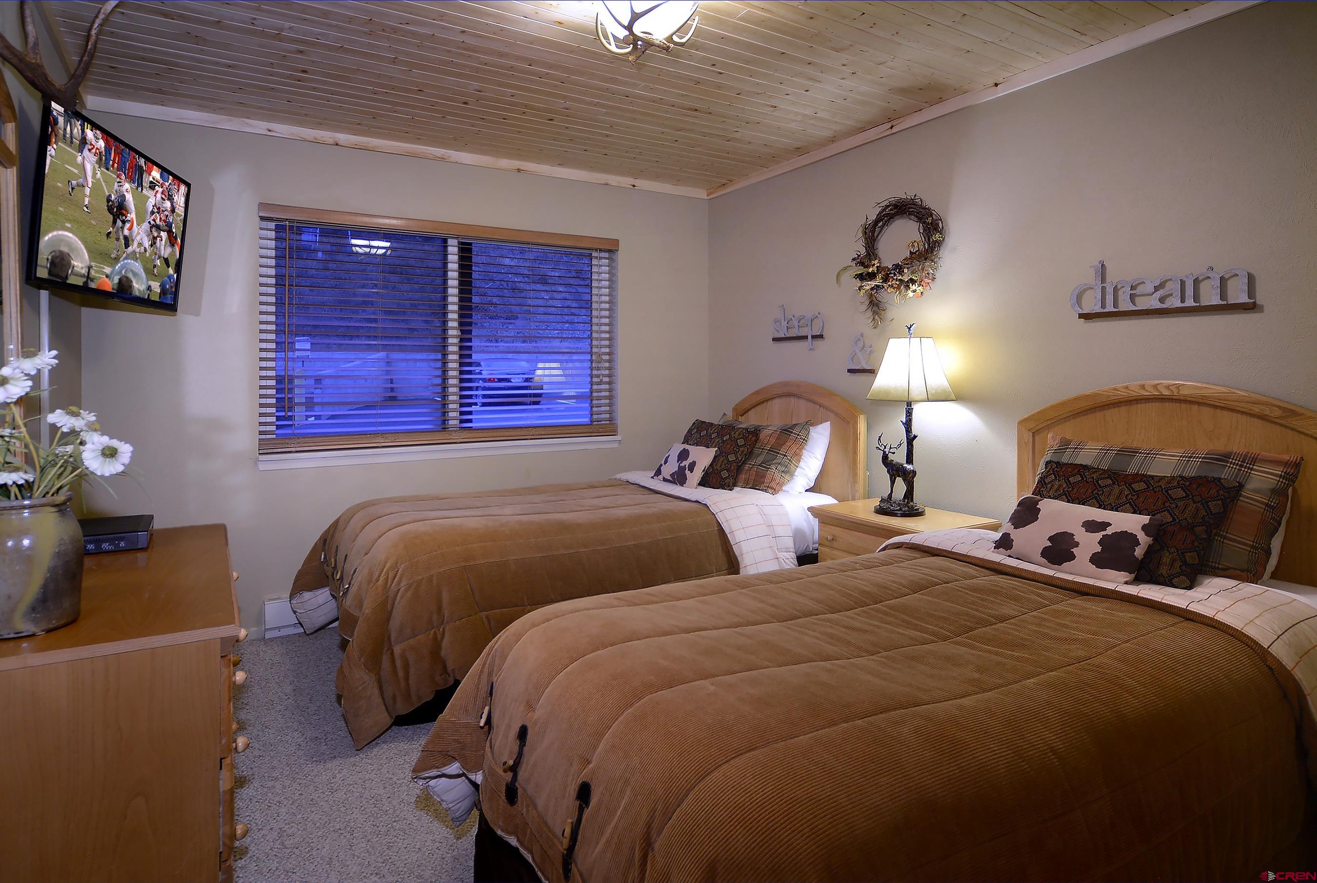 35 Emmons Road, Unit 3 Crested Butte, CO 81225 - Photo 18 of 25 a bedroom with two beds and a chandelier