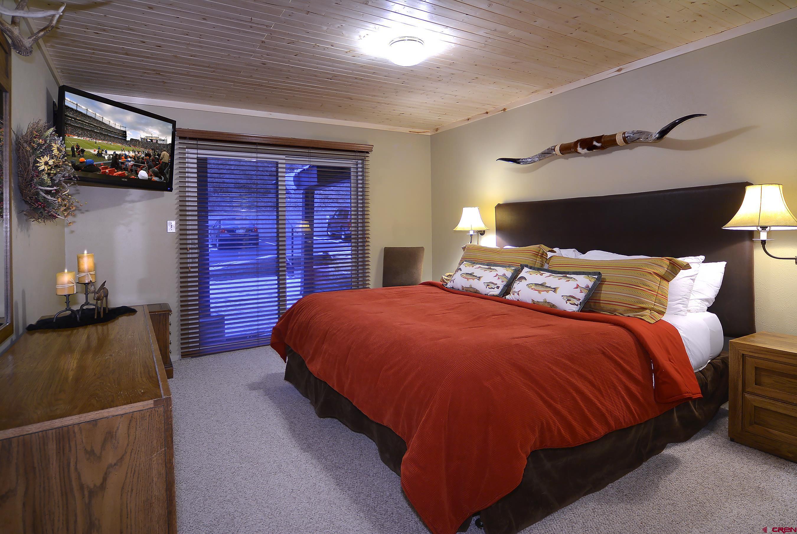 35 Emmons Road, Unit 3 Crested Butte, CO 81225 - Photo 20 of 25 a bedroom with a bed and a lamp with the dresser