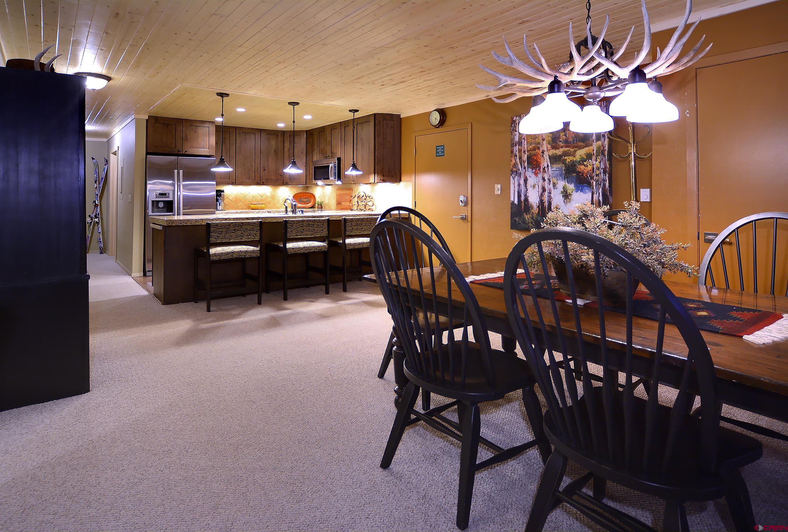 35 Emmons Road, Unit 3 Crested Butte, CO 81225 - Photo 9 of 25 a view of a dining room kitchen with furniture and a chandelier