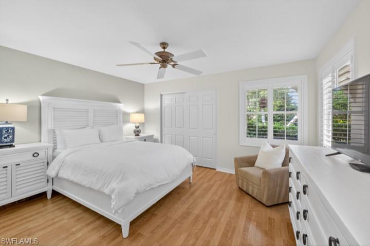 43 Grey Wing Point Naples, FL 34113 - Photo 14 of 50 Bedroom featuring light wood-type flooring, a closet, and a ceiling fan