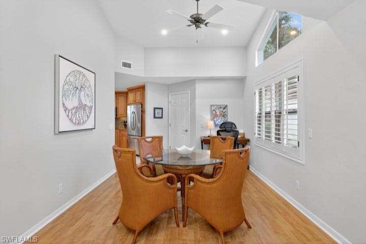 43 Grey Wing Point Naples, FL 34113 - Photo 17 of 50 Dining area featuring light wood-style flooring, ceiling fan, a high ceiling, and recessed lighting