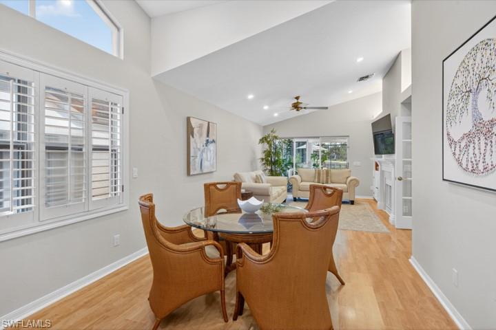 43 Grey Wing Point Naples, FL 34113 - Photo 18 of 50 Dining area with healthy amount of natural light, light wood finished floors, recessed lighting, ceiling fan, and lofted ceiling