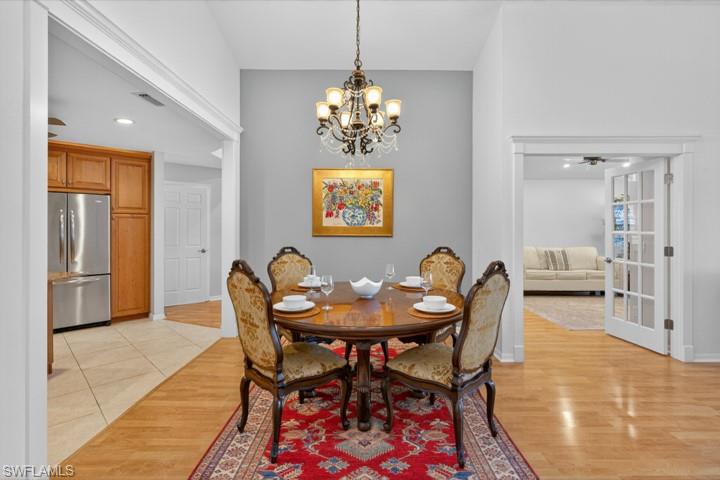 43 Grey Wing Point Naples, FL 34113 - Photo 21 of 50 Dining area featuring a chandelier, light wood-style flooring, ceiling fan, and recessed lighting