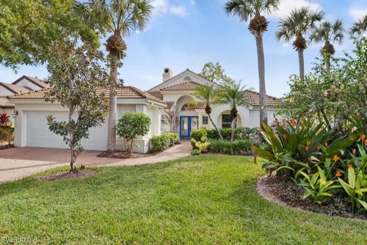 43 Grey Wing Point Naples, FL 34113 - Photo 24 of 50 Mediterranean / spanish home featuring a front lawn, a tile roof, stucco siding, and an attached garage