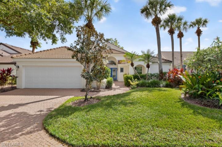 43 Grey Wing Point Naples, FL 34113 - Photo 25 of 50 Mediterranean / spanish-style home featuring decorative driveway, stucco siding, a front lawn, and a garage