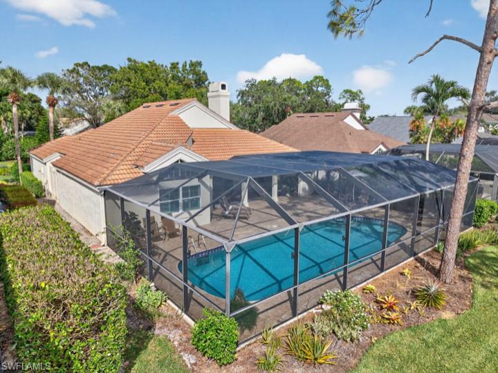 43 Grey Wing Point Naples, FL 34113 - Photo 3 of 50 Swimming pool with a sunroom and a lanai