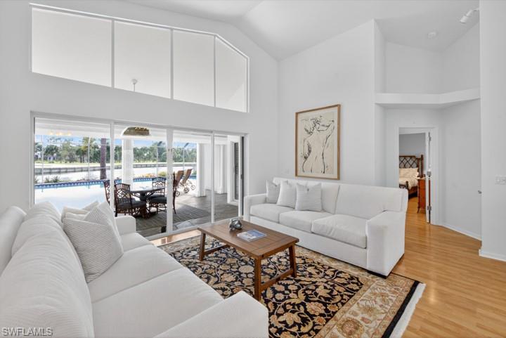 43 Grey Wing Point Naples, FL 34113 - Photo 34 of 50 Living area featuring high vaulted ceiling and light wood finished floors
