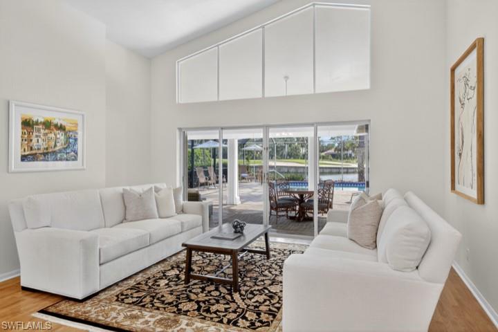 43 Grey Wing Point Naples, FL 34113 - Photo 35 of 50 Living area with light wood-style floors and a high ceiling