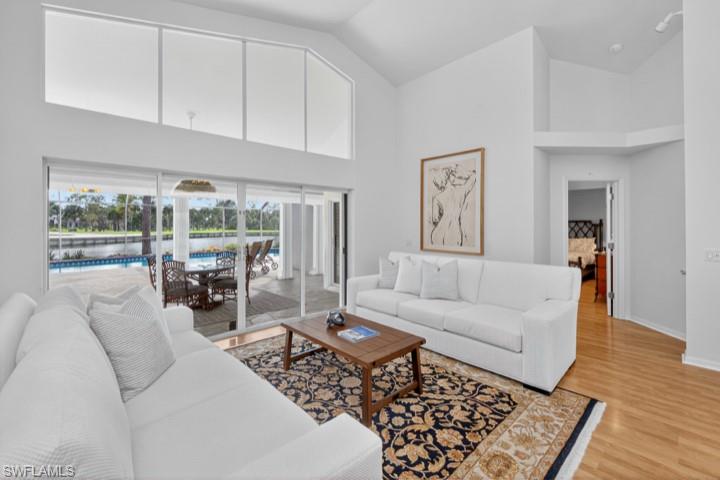 43 Grey Wing Point Naples, FL 34113 - Photo 37 of 50 Living room featuring high vaulted ceiling and light wood finished floors