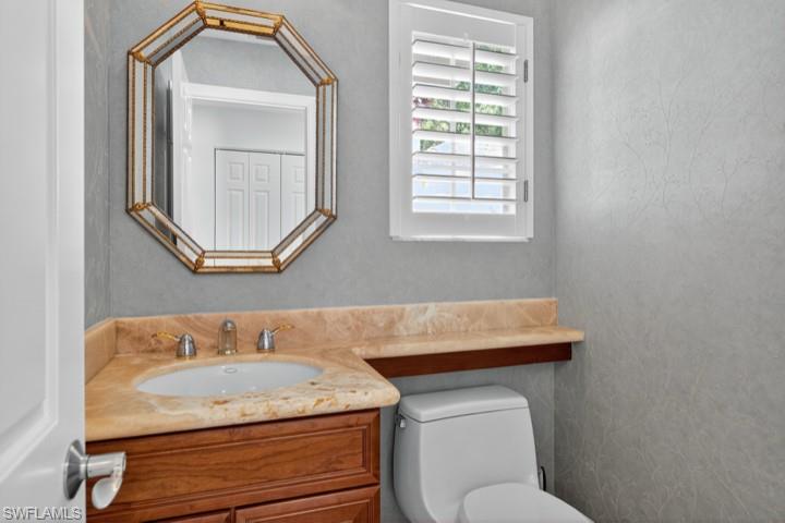 43 Grey Wing Point Naples, FL 34113 - Photo 39 of 50 Bathroom featuring vanity and toilet
