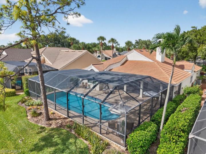 43 Grey Wing Point Naples, FL 34113 - Photo 4 of 50 Swimming pool featuring a lanai, a sunroom, a yard, and a residential view