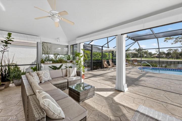 43 Grey Wing Point Naples, FL 34113 - Photo 46 of 50 View of patio featuring glass enclosure, a sunroom, a ceiling fan, and outdoor lounge area