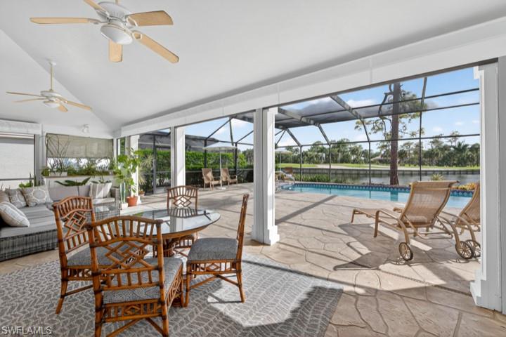 43 Grey Wing Point Naples, FL 34113 - Photo 48 of 50 Sunroom / solarium featuring a patio area, vaulted ceiling, ceiling fan, and an outdoor living space