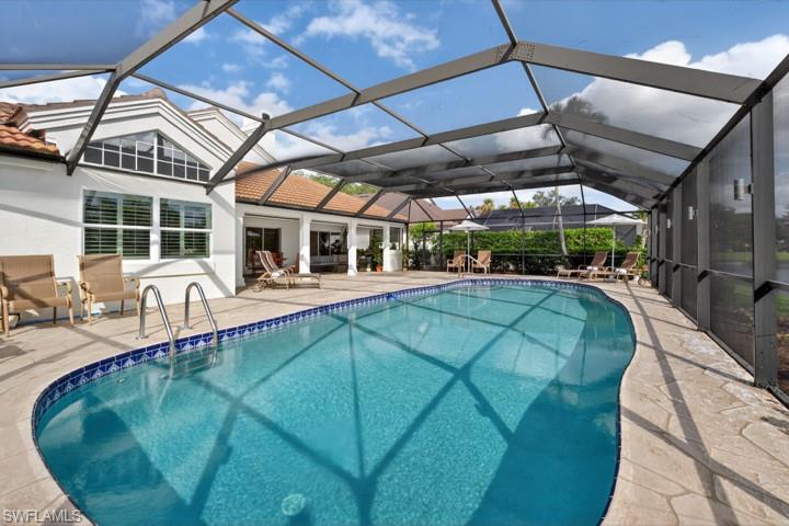 43 Grey Wing Point Naples, FL 34113 - Photo 50 of 50 Outdoor pool with a sunroom, a patio, and glass enclosure