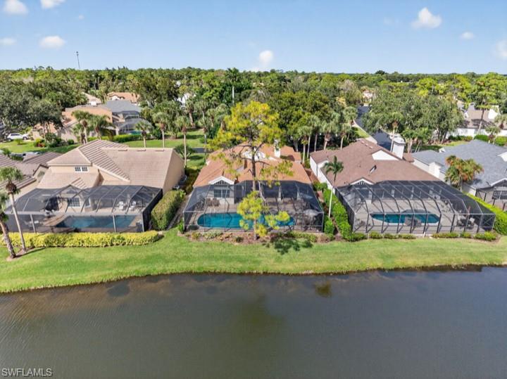 43 Grey Wing Point Naples, FL 34113 - Photo 5 of 50 Aerial perspective of suburban area featuring a large body of water and a tree filled landscape