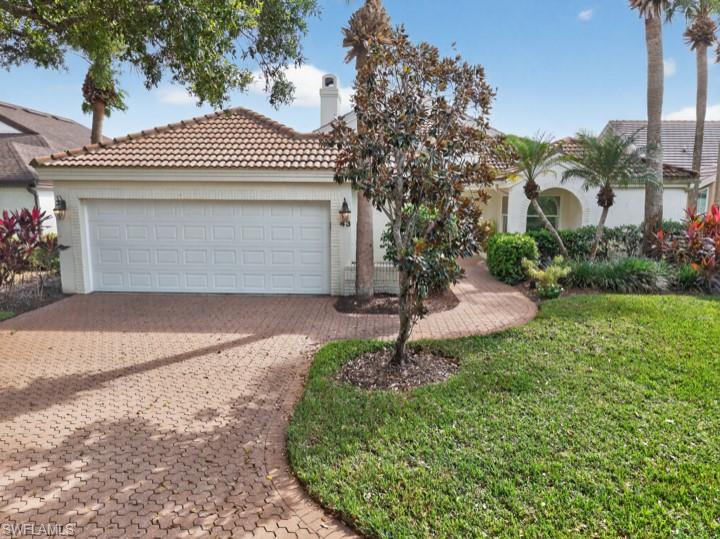 43 Grey Wing Point Naples, FL 34113 - Photo 7 of 50 Mediterranean / spanish-style house featuring a tile roof, a front yard, driveway, a garage, and a chimney
