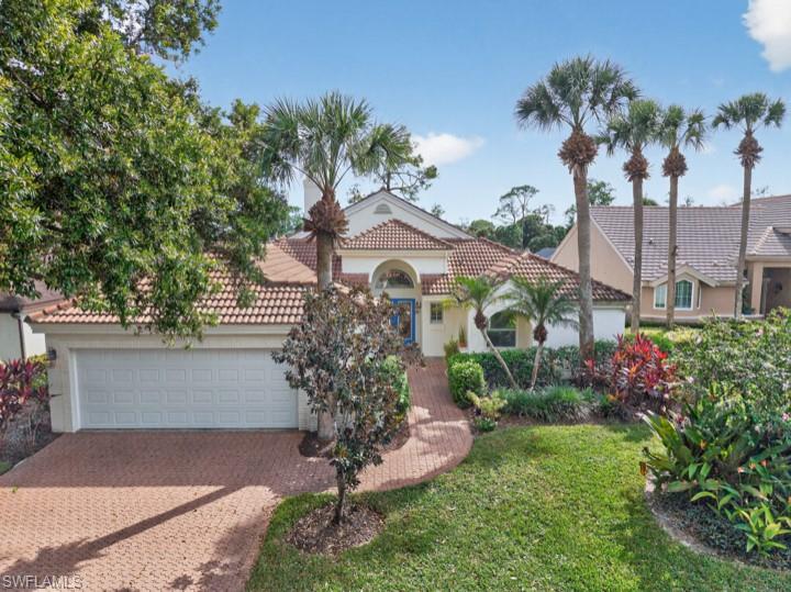 43 Grey Wing Point Naples, FL 34113 - Photo 9 of 50 Mediterranean / spanish home with a tile roof, stucco siding, decorative driveway, a front lawn, and a garage