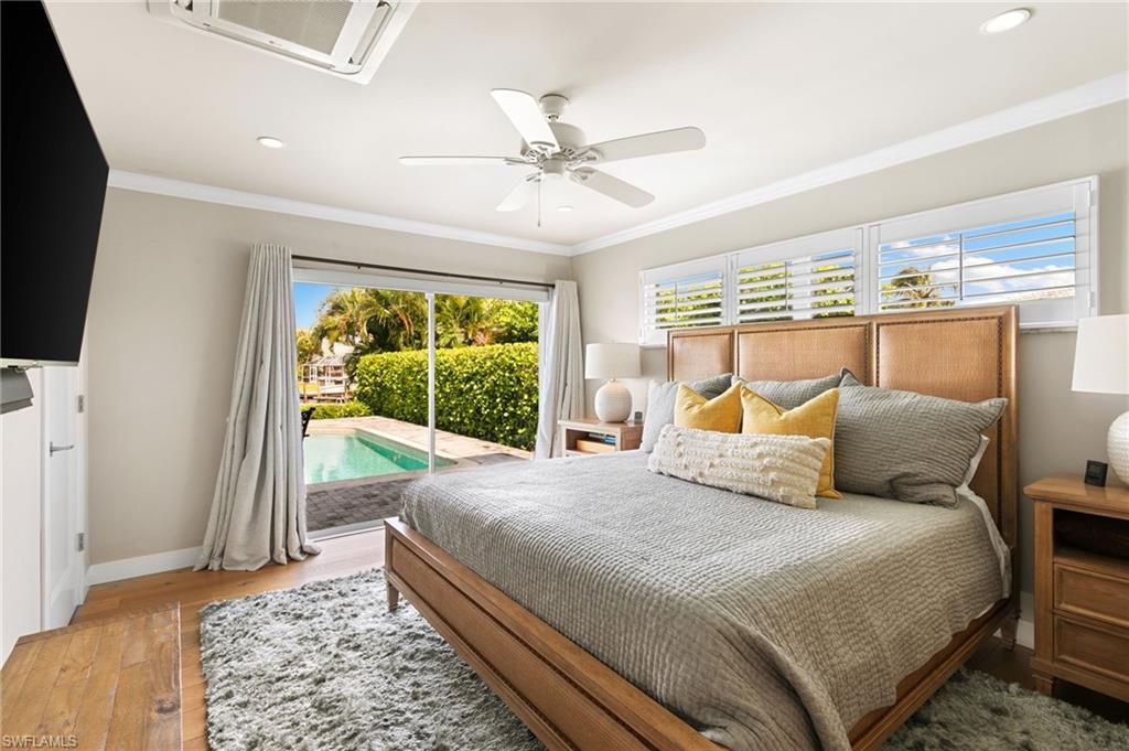 2140 Shad Court Naples, FL 34102 - Photo 40 of 44 a bedroom with a large bed and a window