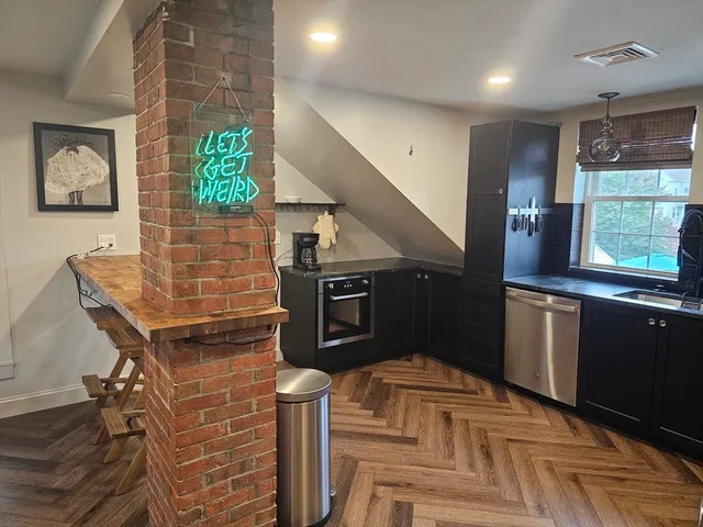 a kitchen with granite countertop a stove and a refrigerator