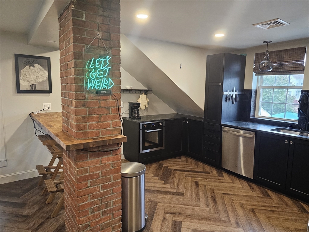 55 Buffum Street, Unit 3 Salem, MA 01970 - Photo 3 of 10 a kitchen with granite countertop a stove and a refrigerator