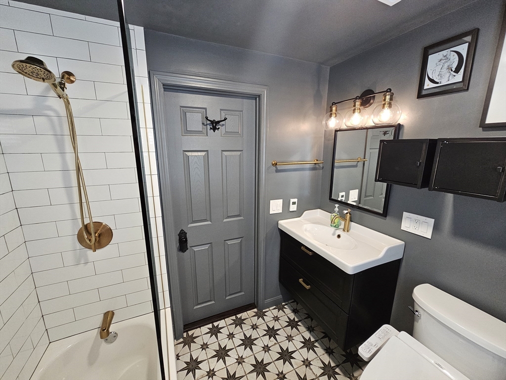 55 Buffum Street, Unit 3 Salem, MA 01970 - Photo 6 of 10 a bathroom with a sink toilet and shower