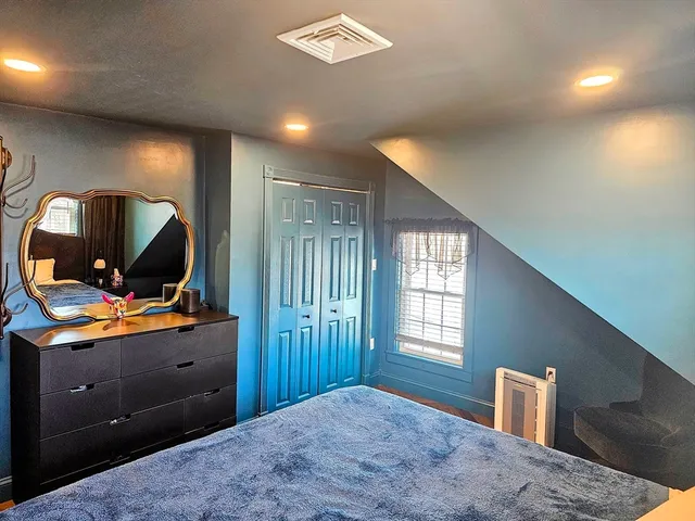 a bedroom with furniture and window