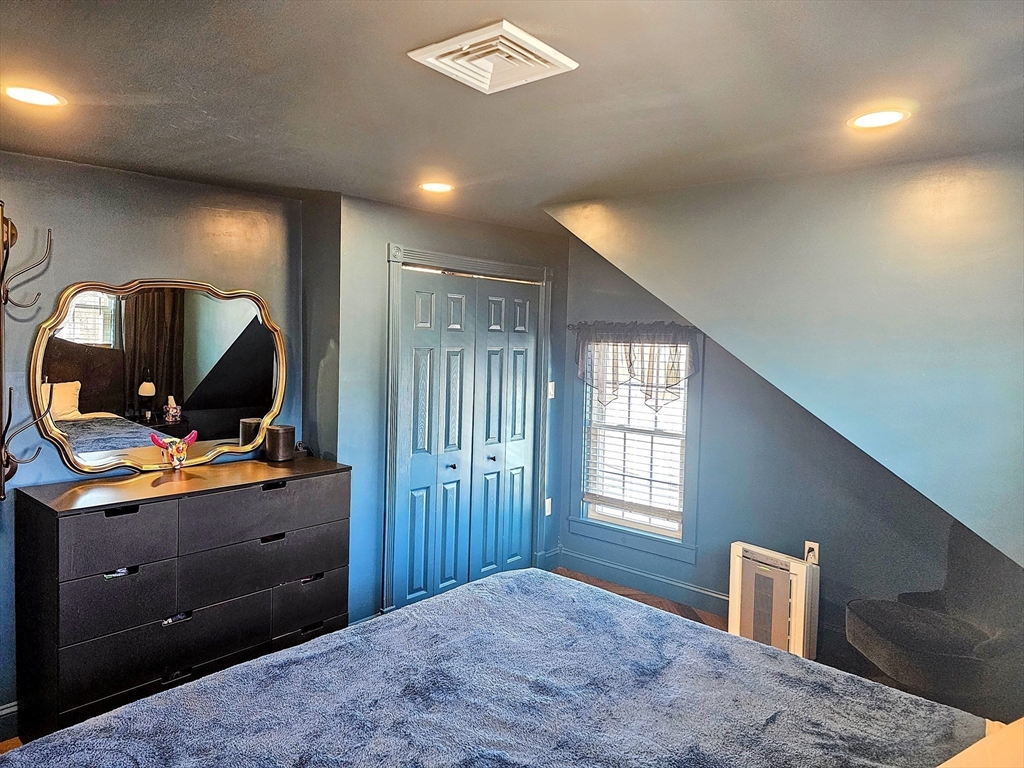 55 Buffum Street, Unit 3 Salem, MA 01970 - Photo 9 of 10 a bedroom with furniture and window