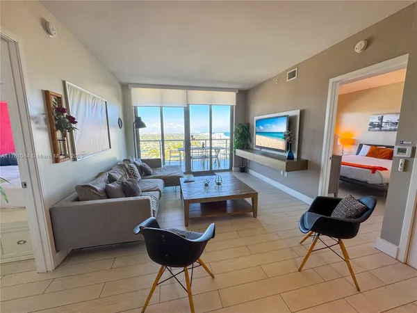 a living room with fireplace furniture and a flat screen tv
