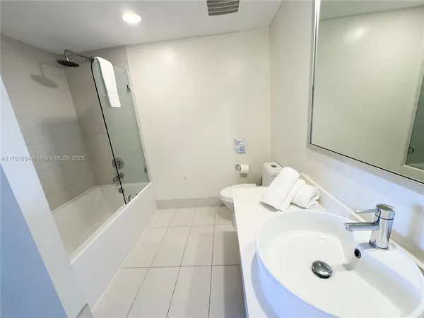a bathroom with a sink and shower