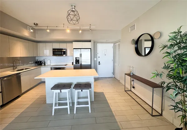 a large kitchen with a table and chairs