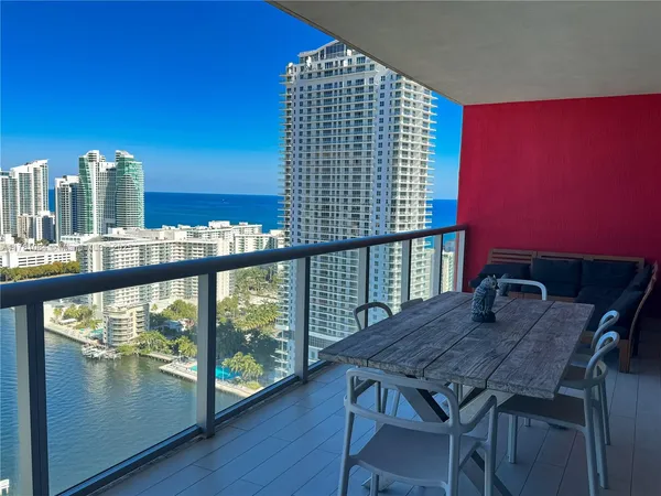 a view of a balcony with two chairs and a table