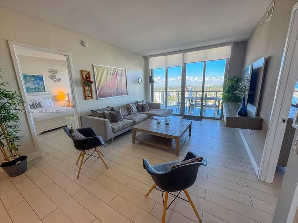 a living room with furniture and a large window