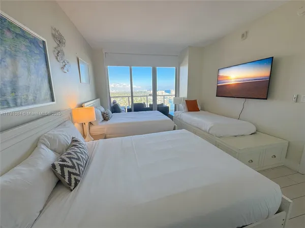 a bedroom with a bed and a lamp