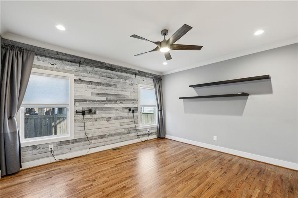 1237 Milton Terrace Southeast Atlanta, GA 30315 - Photo 16 of 28 a view of an empty room with a window and wooden floor
