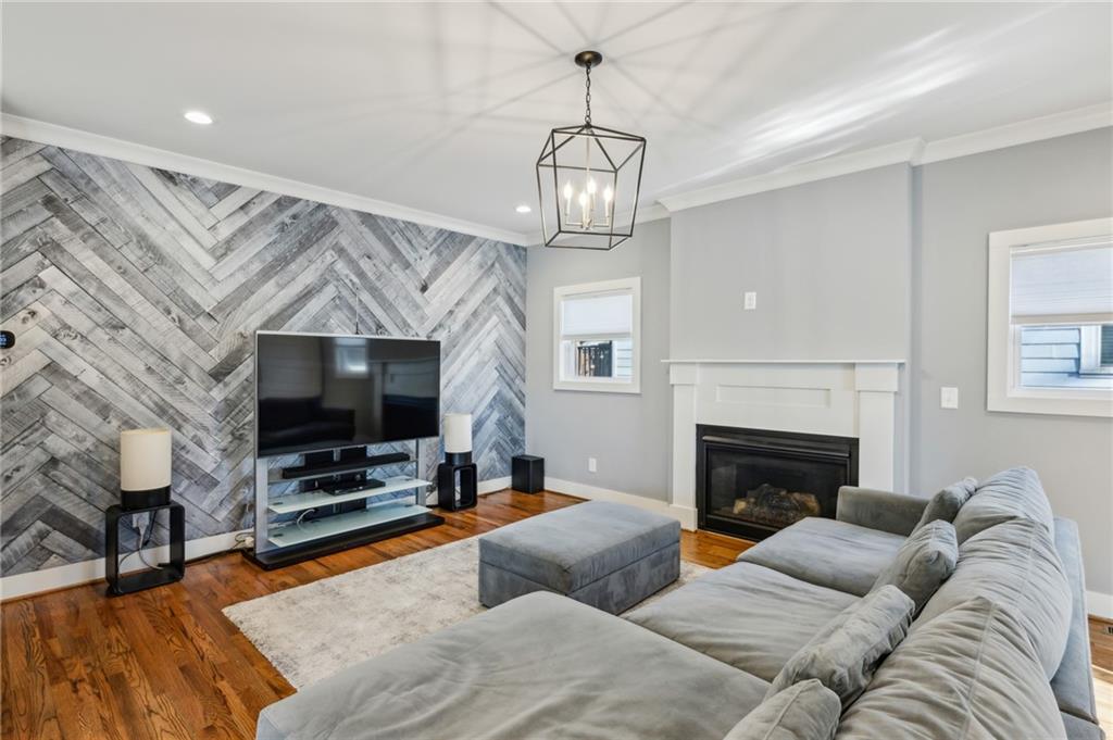 1237 Milton Terrace Southeast Atlanta, GA 30315 - Photo 5 of 28 a living room with furniture a flat screen tv and a fireplace