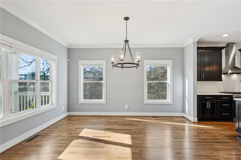 1237 Milton Terrace Southeast Atlanta, GA 30315 - Photo 8 of 28 a view of an empty room with window and wooden floor
