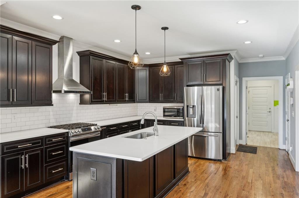 1237 Milton Terrace Southeast Atlanta, GA 30315 - Photo 10 of 28 a kitchen with stainless steel appliances granite countertop a sink a stove and a refrigerator