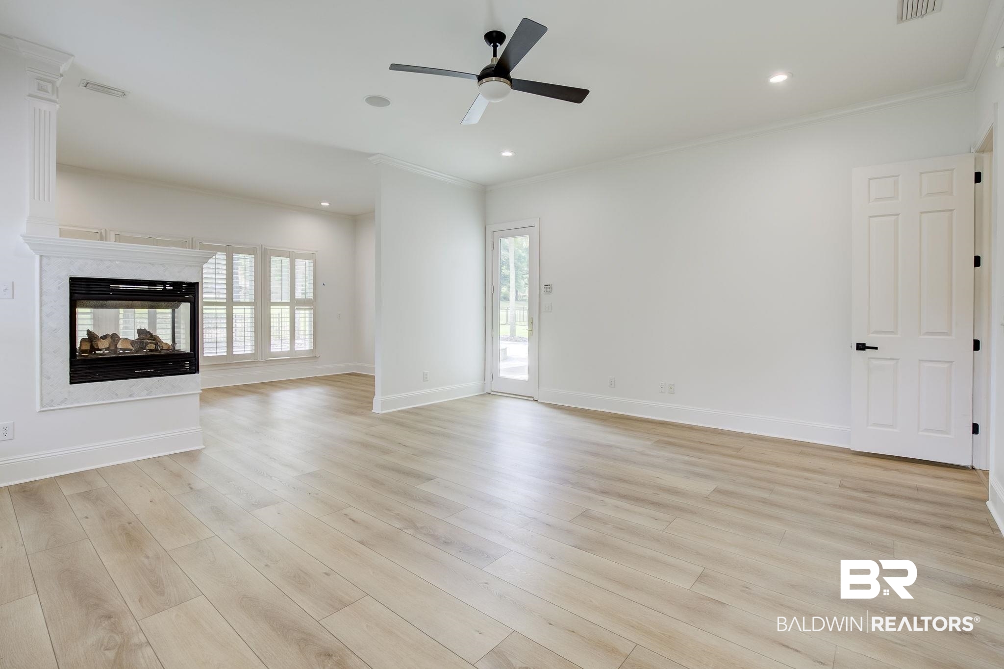 105 High Pines Ridge Fairhope, AL 36532 - Photo 44 of 97 healthy amount of natural light, ceiling fan, a multi sided fireplace, crown molding, and light wood-style floors