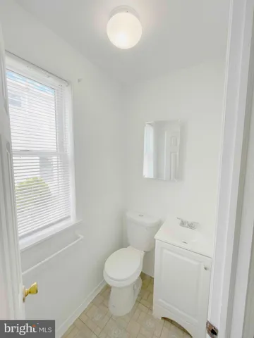 a white toilet sitting next to a bathroom sink