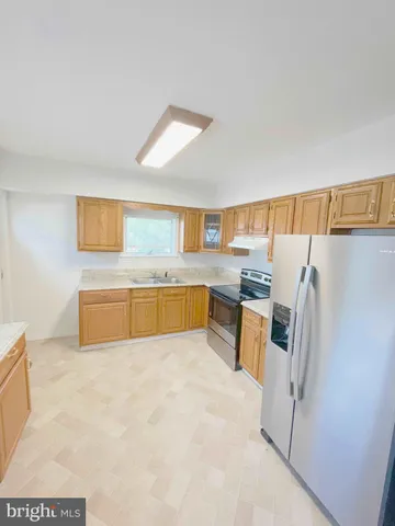 a kitchen with stainless steel appliances a refrigerator and a stove
