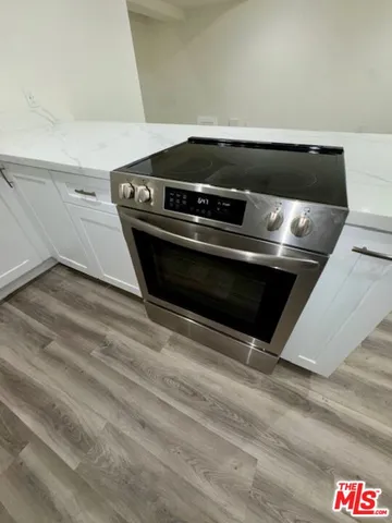 a stove top oven sitting inside of a kitchen