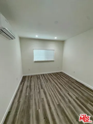 a view of a hallway with wooden floor and entryway